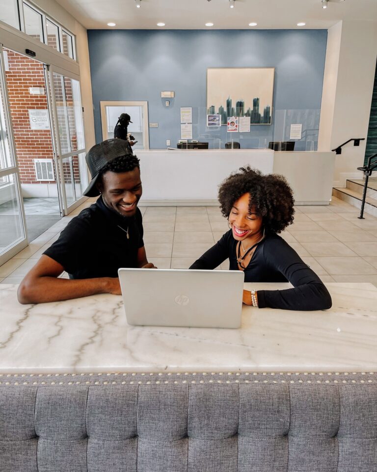 two GSU students on a computer